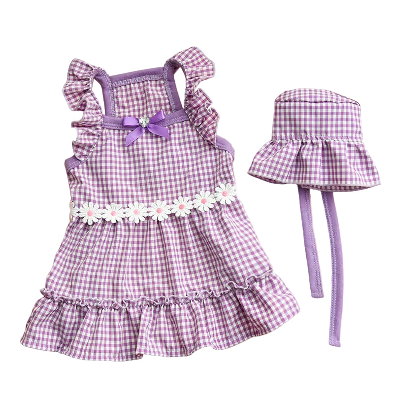 Purple checkered dress with matching hat on a beige surface